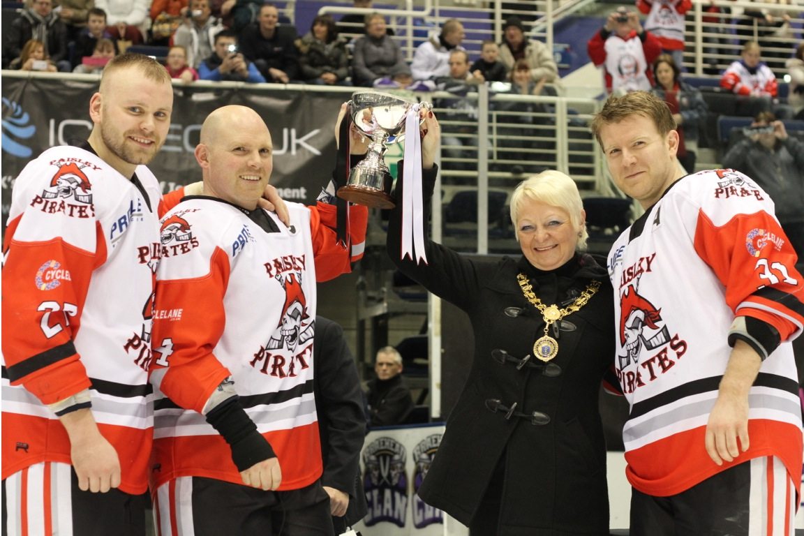 Provost Anne Hall presenting the SNL Trophy to Team Captain John Churchill, flanked by Alternate Captains Chris Turley (on the left) and Mark Hassan (on the right)