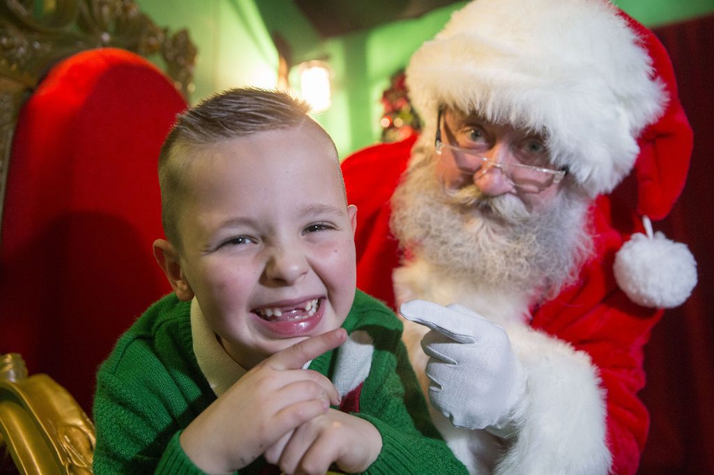 Owen Macdonald, aged seven showing Santa at intu Braehead why he wants two front teeth for Christmas