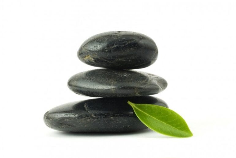 Pebbles stack and green leaf