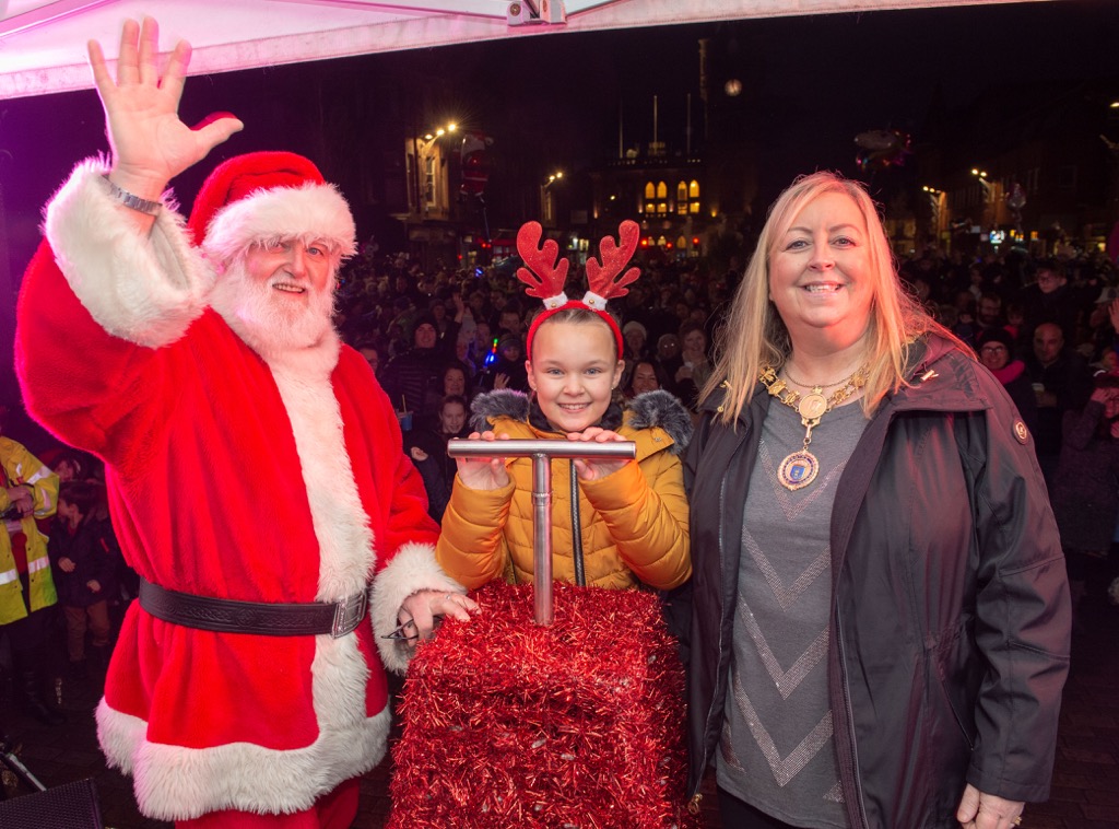 Competition winner Ava, 9, with Provost Lorraine Cameron and Santa, moments before the big switch on