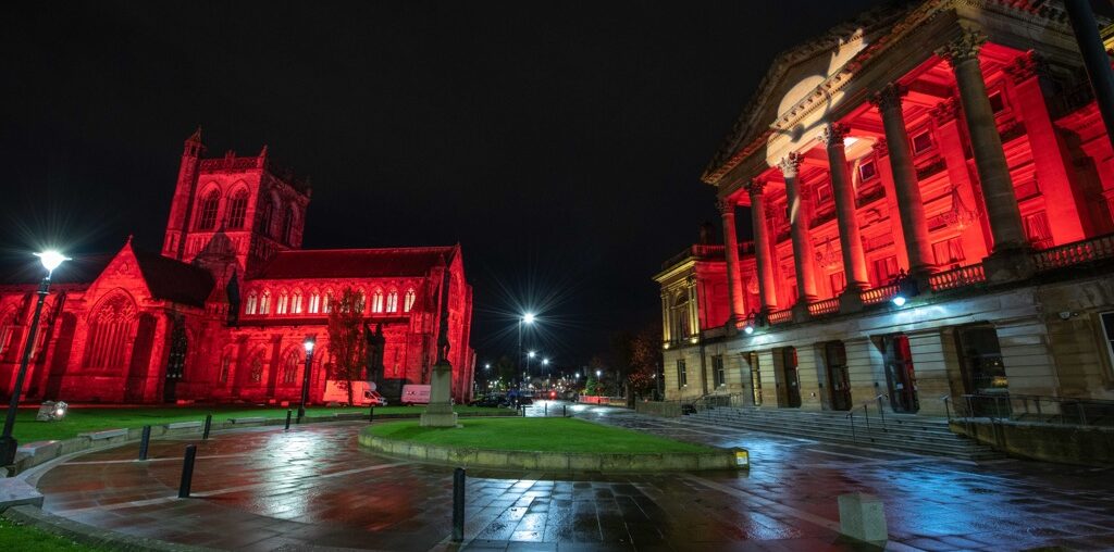 Paisley Abbey and Paisley Town Hall lit up in red