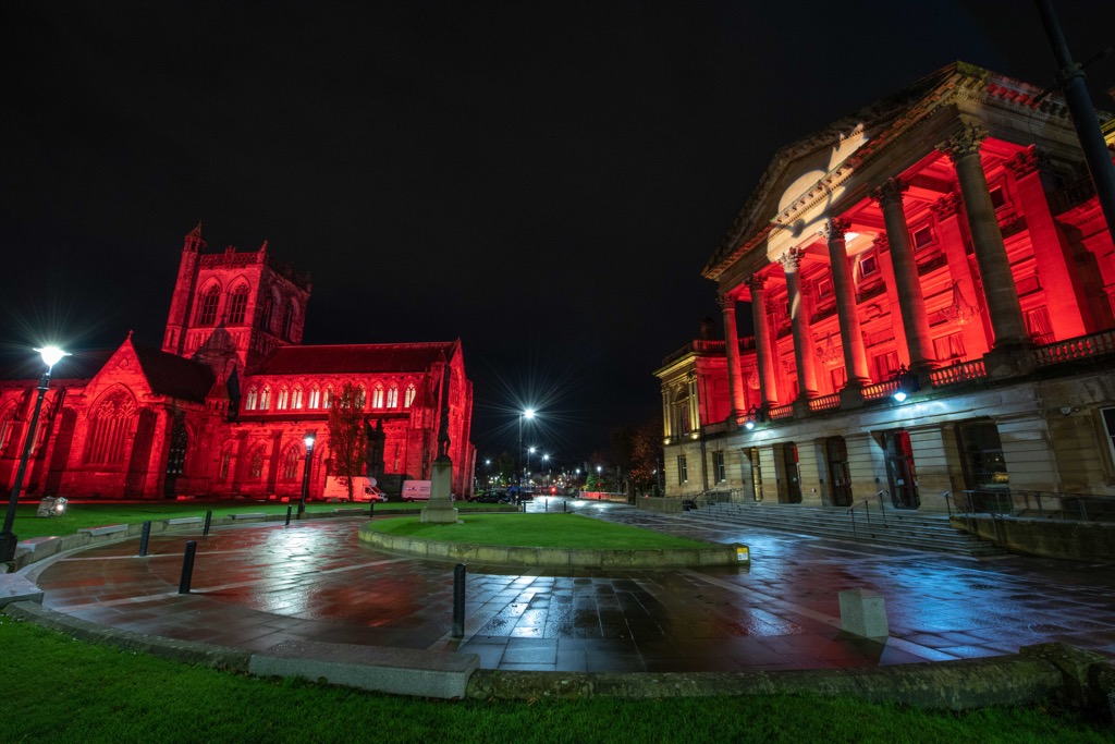 Paisley Abbey and Paisley Town Hall lit up in red