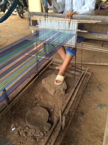 Artisan in Cambodia weaving the fair trade tartan