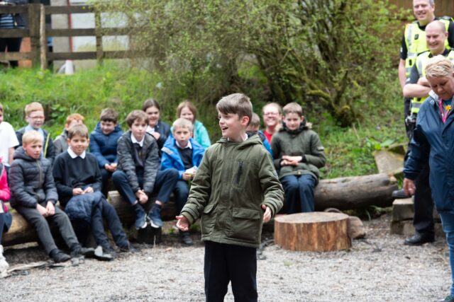 A pupil leads the group with a song