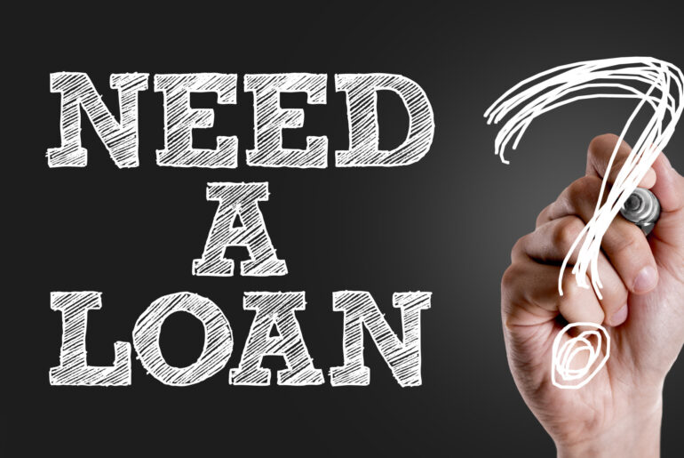 Hand writing the text: Need a Loan?