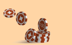 Several brown and white casino chips are stacked, with a few chips appearing to be tossed into the air on a plain beige background. One chip displays the number 100.
