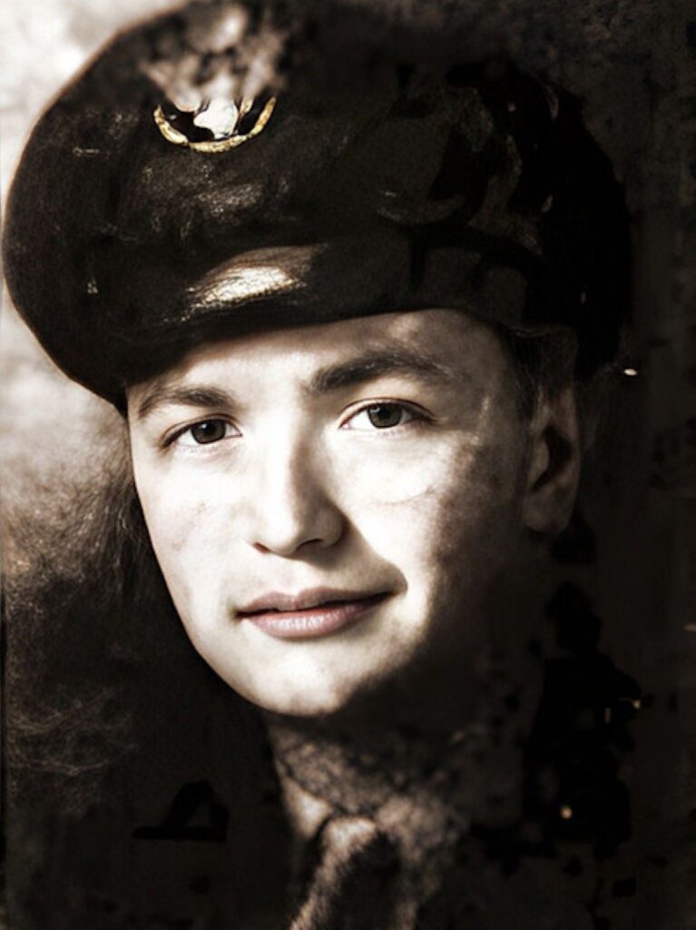 A vintage portrait of a person wearing a dark military-style cap and uniform, looking directly at the camera with a slight smile. The image is in sepia tones and has an old, weathered appearance.